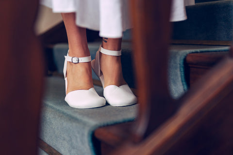 A woman in barefoot sandals standing on her tip-toes; the sole is copying the shape of the foot