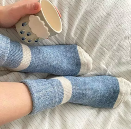 A pair of cute, comfortable blue Merino wool socks with a soft, cozy texture, designed for warmth, breathability, and all-day comfort.